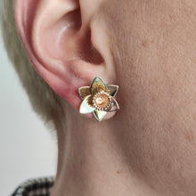 Load image into Gallery viewer, A yellow gold daffodil flower stud earring, modelled in an ear
