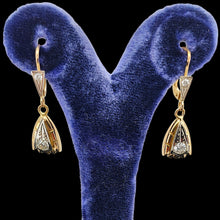 Load image into Gallery viewer, A pair of yellow and white gold diamond set drop earrings, in a blue earring stand
