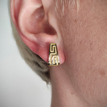 Load image into Gallery viewer, A yellow gold Greek key design half hoop earring, modelled in an ear
