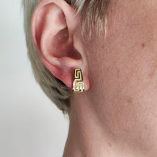 Load image into Gallery viewer, A yellow gold Greek key design half hoop earring, modelled in an ear
