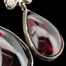 Load image into Gallery viewer, A pair of pear shaped garnet and rose cut diamond earrings in gold and silver, on a black background
