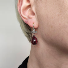Load image into Gallery viewer, A pear shaped garnet and rose cut diamond earring in gold and silver, modelled in an ear

