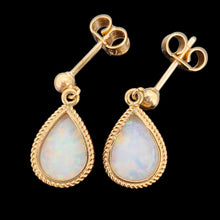 Load image into Gallery viewer, A pair of pear shaped opal drop earrings in yellow gold, on a black background
