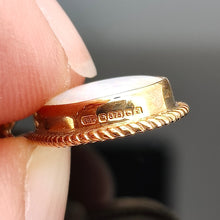 Load image into Gallery viewer, A close-up of a 9 carat gold hallmark on the side of an earring, held in a hand
