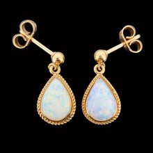 Load image into Gallery viewer, A pair of pear shaped opal drop earrings in yellow gold, on a black background
