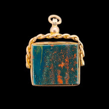 Load image into Gallery viewer, A bloodstone swivel fob in yellow gold, on a black background

