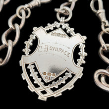 Load image into Gallery viewer, A silver Albert watch chain with large oval links, two lobster clasps, a T-bar and a shield shaped fob medal
