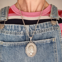 Load image into Gallery viewer, Person wearing a silver necklace with a pendant, overalls, and a striped shirt
