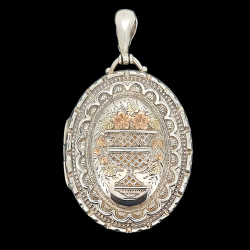 Decorative pendant with intricate designs on a black background