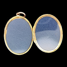 Load image into Gallery viewer, A yellow gold locket pendant, open, showing the inside, against a black background
