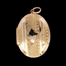 Load image into Gallery viewer, An oval yellow gold locket pendant with engraving, against a black background
