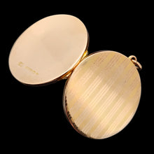 Load image into Gallery viewer, A circular yellow gold locket with pinstripe engraving open
