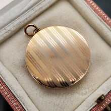 Load image into Gallery viewer, A circular yellow gold locket with pinstripe engraving, in an antique box

