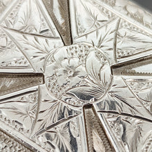 Load image into Gallery viewer, A close-up of flower engraving on a silver locket
