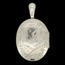 Load image into Gallery viewer, An intricate engraved oval locket pendant in silver, on a black background
