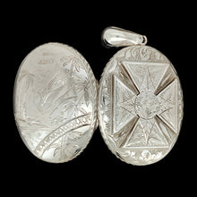Load image into Gallery viewer, An intricate engraved oval locket pendant in silver, on a black background
