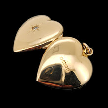 Load image into Gallery viewer, A yellow gold heart shaped locket with a diamond, on a black background
