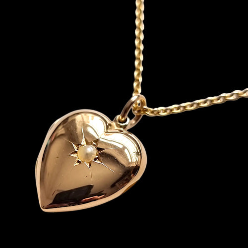 Antique 15ct Gold Pearl Heart Locket with 15ct Gold Chain on a black background