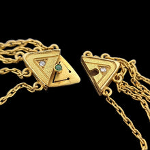Load image into Gallery viewer, Gold emerald and diamond clasp on a black background
