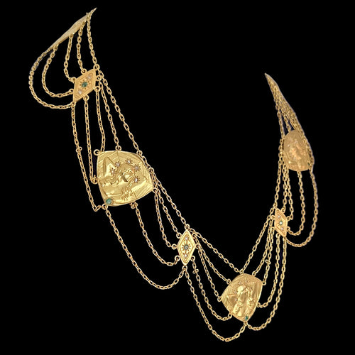 Gold necklace with multiple chains and decorative pendants on a black background
