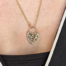 Load image into Gallery viewer, Gold heart-shaped pendant necklace on a person&#39;s neck
