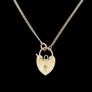 Gold heart-shaped padlock necklace on a black background