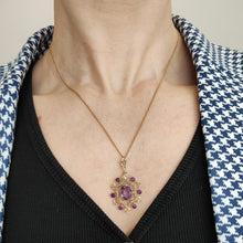 Load image into Gallery viewer, An amethyst and seed pearl fancy pendant in yellow gold with a curb link chain, modelled by a woman
