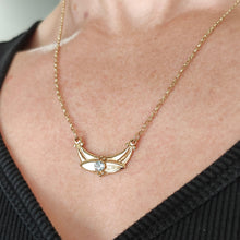 Load image into Gallery viewer, A yellow gold pendant necklace with a round aquamarine, modelled by a woman

