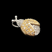 Load image into Gallery viewer, A yellow and white gold diamond set ladybird pendant, on a black background
