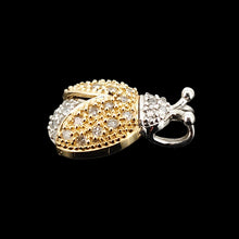 Load image into Gallery viewer, A yellow and white gold diamond set ladybird pendant, on a black background
