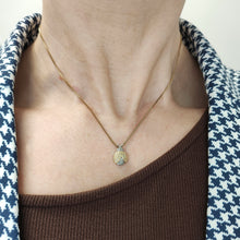 Load image into Gallery viewer, A yellow and white gold diamond set ladybird pendant, on a gold chain, modelled on a woman
