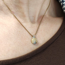 Load image into Gallery viewer, A yellow and white gold diamond set ladybird pendant, on a gold chain, modelled on a woman
