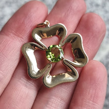 Load image into Gallery viewer, Vintage 9ct Gold Peridot Four Leaf Clover Pendant in hand
