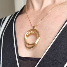 Load image into Gallery viewer, Vintage 14k Gold Pearl Double Circle Pendant modelled with chain
