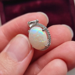 18ct White Gold Opal and Diamond Cluster Pendant in hand