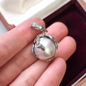 18ct White Gold Abstract Pearl and Diamond Pendant in hand