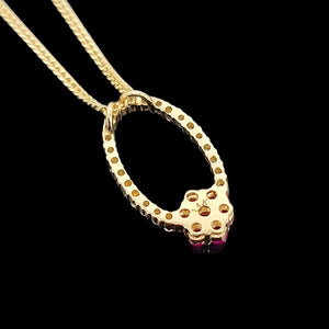 14K Yellow Gold Ruby and Diamond Cluster Pendant back view, with curb link chain, on a black background