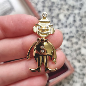 Vintage 18ct Gold Diamond Articulated Clown Pendant in hand