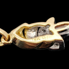 Load image into Gallery viewer, A yellow and white gold diamond set leaf shaped pendant, on a black background
