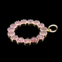 Load image into Gallery viewer, A circular yellow gold pendant with almandine garnets, on a black background
