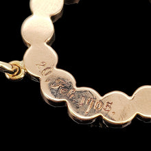 Load image into Gallery viewer, A yellow gold open circle pendant engraved 20, Feb. 1905. on a black background
