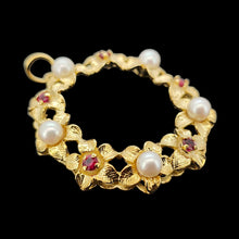Load image into Gallery viewer, A yellow gold ruby and pearl flower open circle pendant, on a black background

