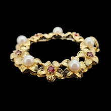 Load image into Gallery viewer, A yellow gold ruby and pearl flower open circle pendant, on a black background
