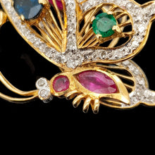 Load image into Gallery viewer, A yellow gold butterfly pendant with diamonds, rubies, a sapphire and an emerald
