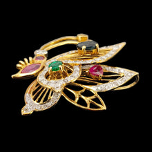 Load image into Gallery viewer, A yellow gold butterfly pendant with diamonds, rubies, a sapphire and an emerald
