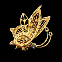 Load image into Gallery viewer, A yellow gold butterfly pendant with diamonds, rubies, a sapphire and an emerald
