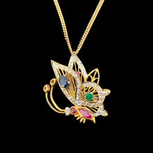 Load image into Gallery viewer, A yellow gold butterfly pendant with diamonds, rubies, a sapphire and an emerald, with a gold curb chain

