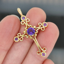 Load image into Gallery viewer, A fancy design cross pendant with five amethysts held in a hand
