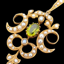 Load image into Gallery viewer, A peridot and pearl Art Nouveau style pendant in yellow gold, on a black background
