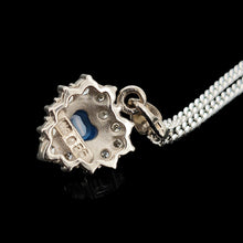 Load image into Gallery viewer, A heart shaped sapphire and diamond cluster pendant, with a curb link chain, on a black background
